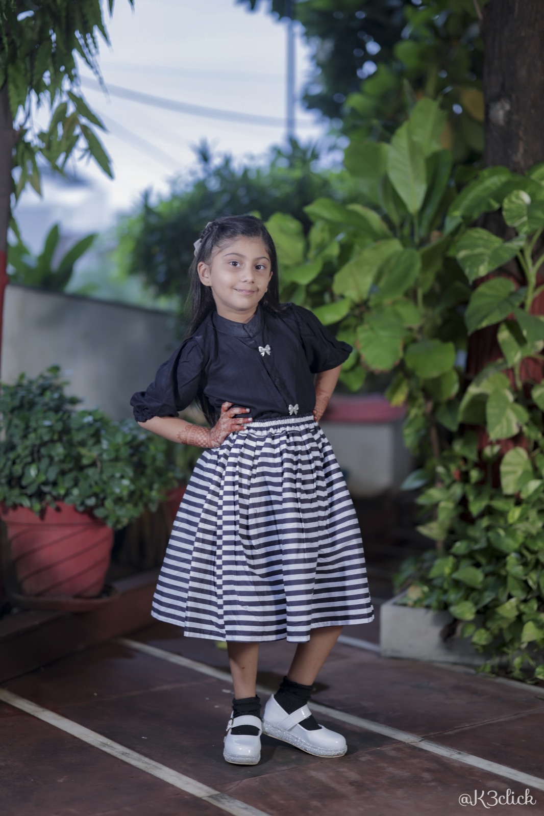 Black blouse with striped skirt